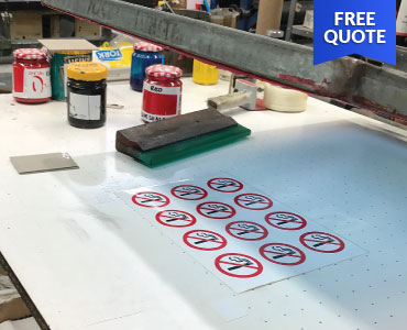 A screen printing bench with a squeegee